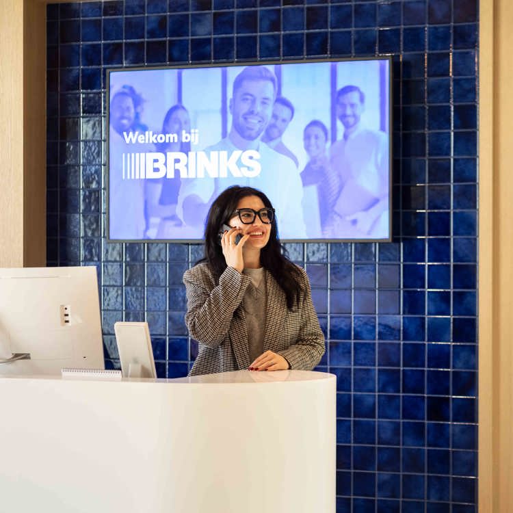 A smiling woman answering a phone